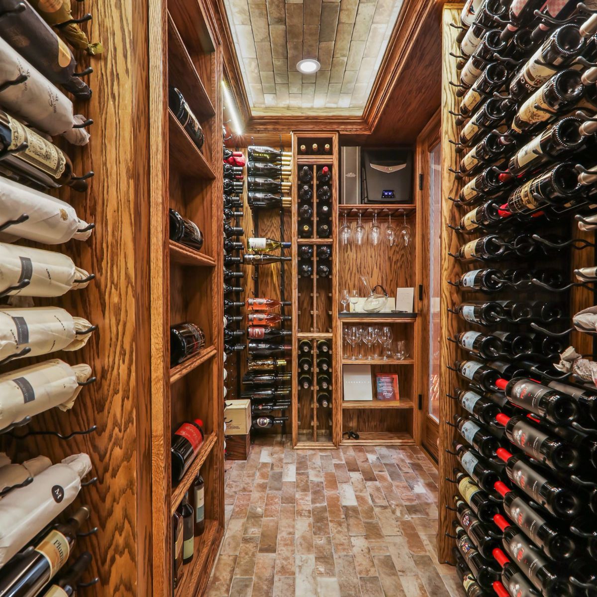 VintageView 5 Foot wall mounted wine rack installed in a custom wood wine cellar with full height label forward bottle storage