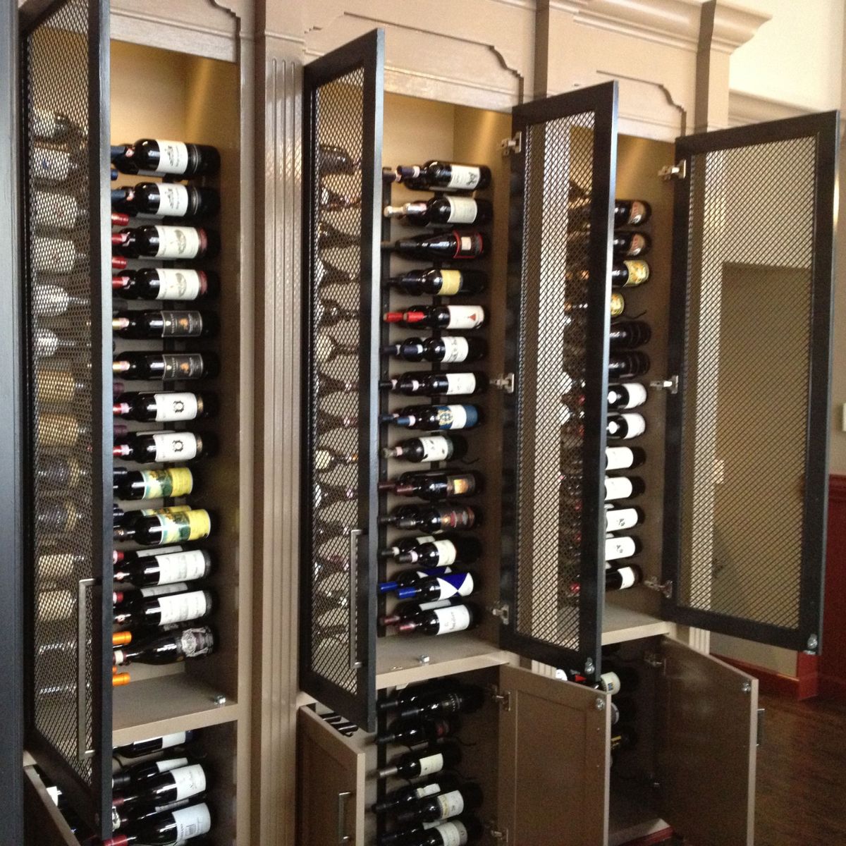 VintageView 5 Foot wall mounted wine rack installed inside industrial metal cabinets with mesh doors and label forward wine storage
