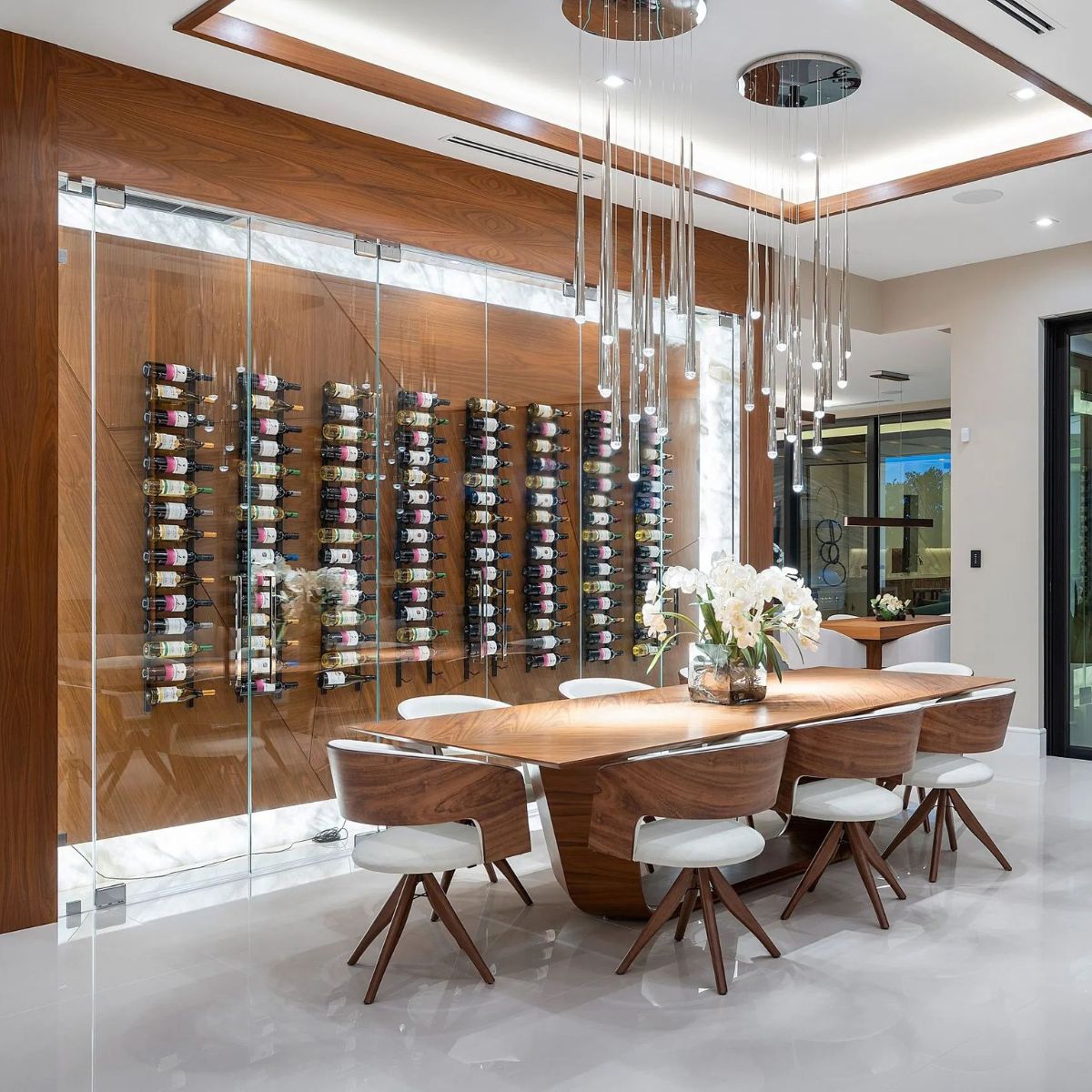 VintageView 5 Foot wall mounted wine rack installed in a modern dining room with glass enclosure and label forward bottle display