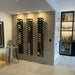 VintageView 6 Foot wall mounted wine storage rack installed on a brick accent wall in a modern home bar with label forward bottle display