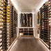 VintageView 7 Foot wall mounted wine storage rack lining a full depth walk in wine room with symmetrical label forward bottle storage