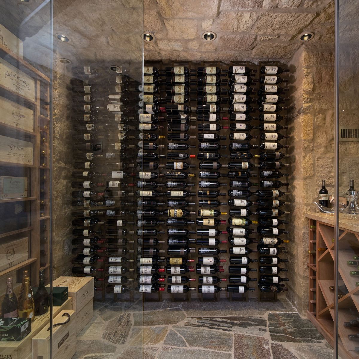 VintageView 8 Foot wall mounted wine storage rack installed in a stone wine cellar with label forward bottle storage