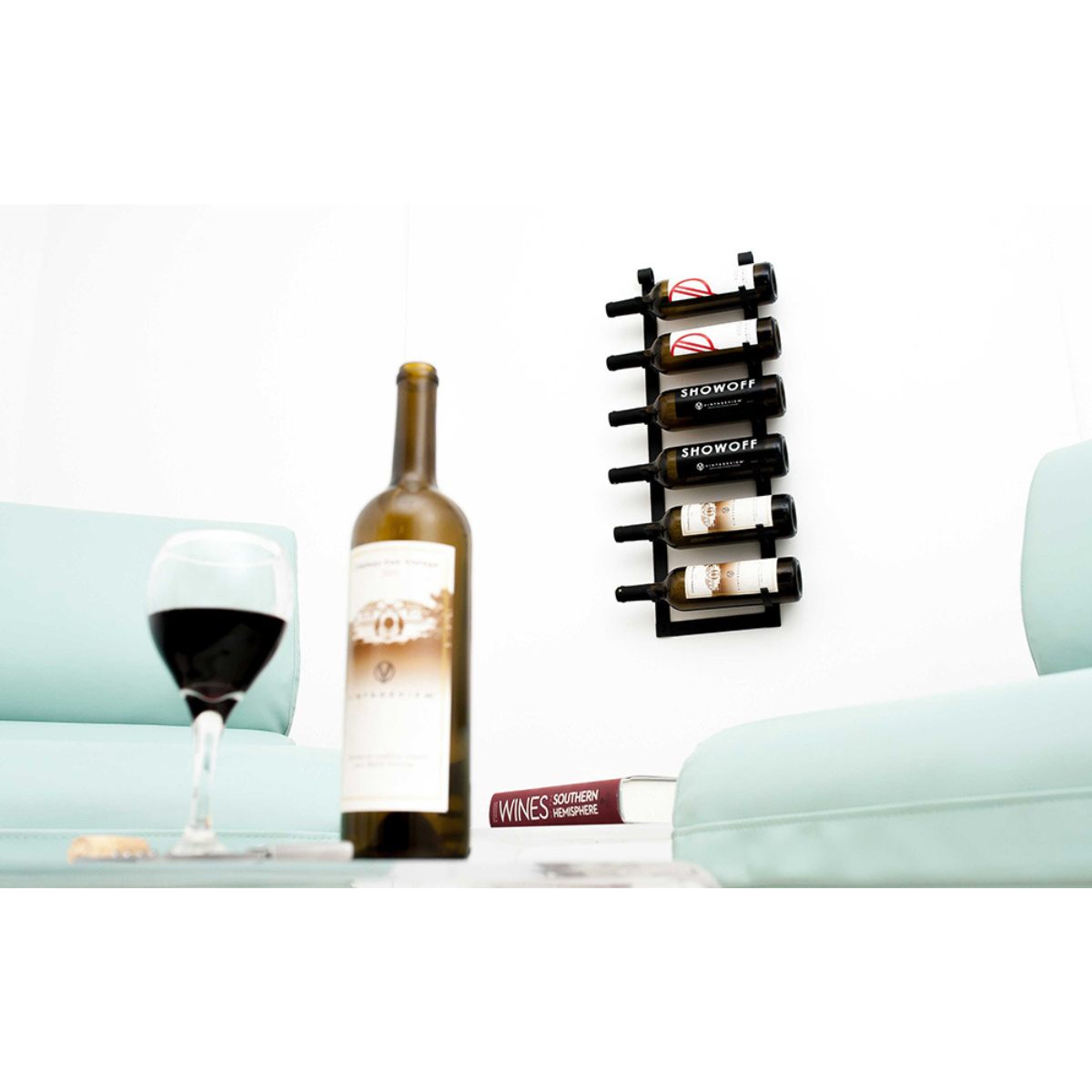 VintageView Le Rustique wall mounted metal wine rack installed in a modern living room