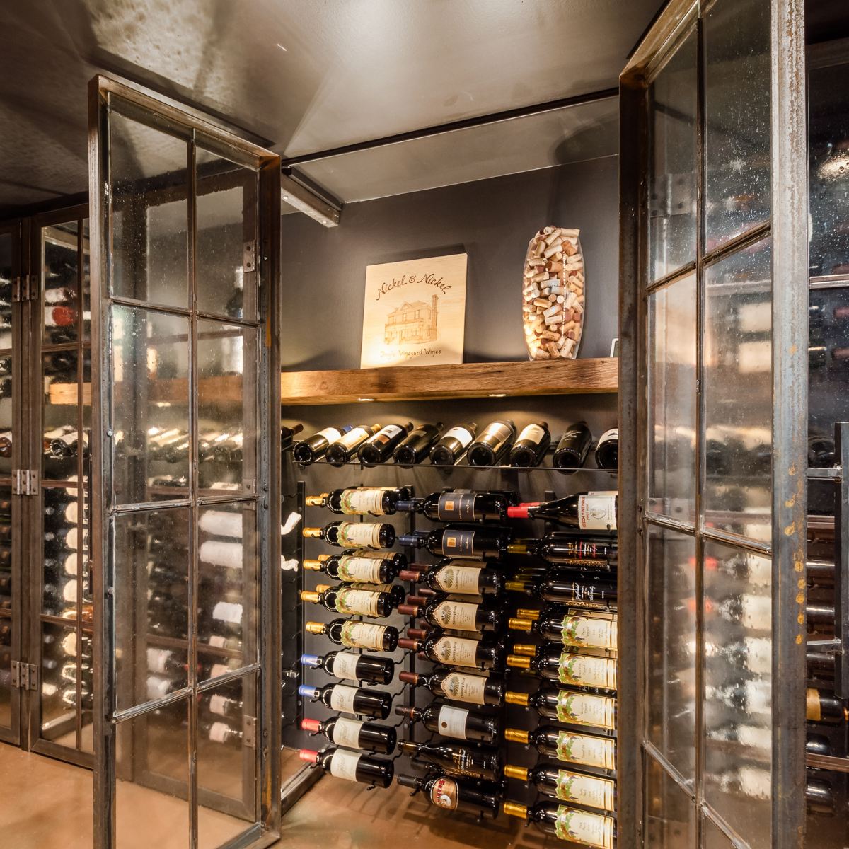 VintageView Presentation Row wall-mounted wine rack installed inside a glass-door wine cellar