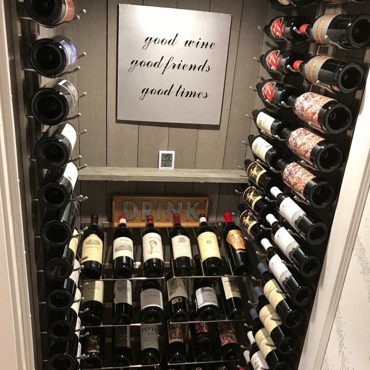 VintageView Presentation Row wall mounted wine rack installed inside a glass enclosed wine cellar with horizontal bottle display
