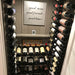 VintageView Presentation Row wall mounted wine rack installed inside a glass enclosed wine cellar with horizontal bottle display