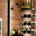 VintageView Presentation Row wall-mounted wine rack installed on a wood accent wall with display shelf