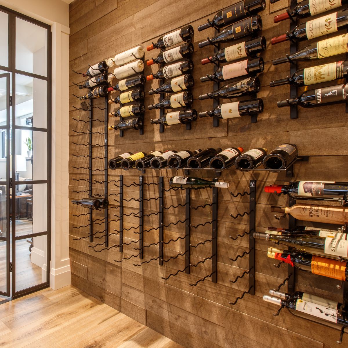 VintageView Presentation Row wall mounted wine rack on a wood panel feature wall with mixed wine bottle storage