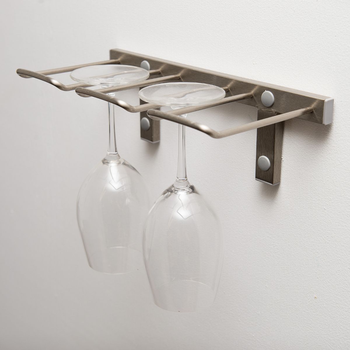 Brushed nickel wall mounted wine glass stemware rack showing secure glass holders and minimalist mounting design