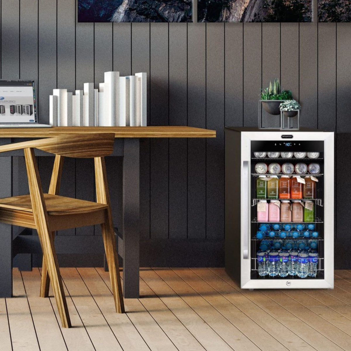 Whynter BR-1211DS 136-Can Stainless Steel Beverage Refrigerator - filled with assorted cans and bottles beside a wooden desk in a modern office space